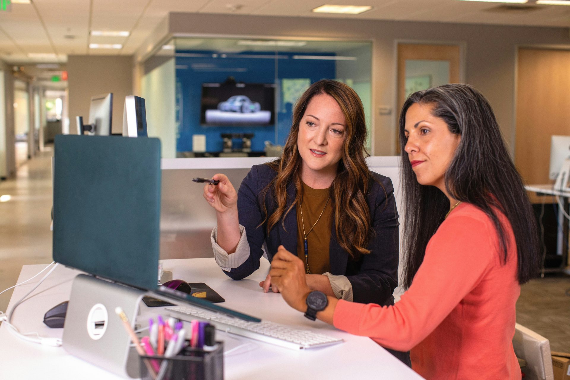 Two women discussing at computer